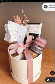 a white box filled with lots of different types of food and sweets on top of a wooden table