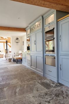 Tall bespoke traditional kitchen light blue units integrating double oven and warming drawer Traditional Kitchen Lighting, Small Pantry, Slate Flooring