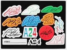 various stickers with numbers and symbols on black background, including the number 24 in different colors