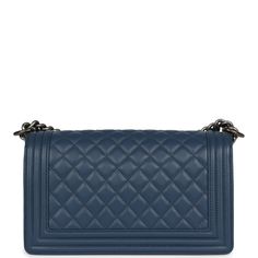 This Chanel medium Boy bag is in blue lambskin leather with ruthenium hardware and features a full front flap with the Le Boy CC push lock closure and a ruthenium tone chain link and blue leather padded shoulder/crossbody strap.The interior is lined in blue grossgrain fabric with an open pocket on rear wall.Collection: 26 Series (2018-2019)Origin: FranceCondition: Never wornAccompanied by: Chanel dustbag, carebook, felt, COA cardMeasurements: 9.8" width x 5.9" height x 3.5" depth; 22" strap drop (12" doubled) Hermes Birkin 25, Birkin 25, Celine Bags, Fendi Bags, Lambskin Leather, Blue Bags, Blue Leather, Dior Bag, Chain Link