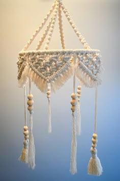 a white chandelier with tassels hanging from it