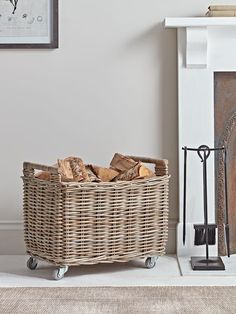 a wicker basket sitting on top of a white floor next to a fire place