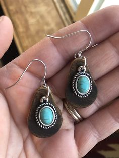 "Delicate pull up leather earrings with a small turquoise colored accent. Each earring teardrop is cut from our pull up leather that has an incredible patina. We then finish the look with a dainty turquoise rope-bordered accent. These are small, yet eye-catching and unusually lightweight. Leather piece approx: 1\"x .75\" Tag us on Instagram @doubleAconnected to be featured! All items produced by Double A Connected Leatherworks are handmade, many to-order. In working with leather there will be sl Southwestern Style Brown Teardrop Jewelry, Brown Southwestern Teardrop Jewelry, Southwestern Brown Teardrop Jewelry, Southwestern Style Teardrop Brown Jewelry, Bohemian Turquoise Leather Earrings, Handmade Leather Jewelry Diy, Rustic Brown Teardrop Jewelry, Rustic Leather Dangle Jewelry, Bohemian Leather Teardrop Earrings