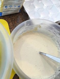 a bowl filled with batter next to a container of yogurt