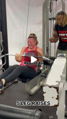 a woman is sitting on a bench in the gym with another woman standing behind her