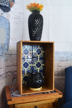 a wooden shelf with a vase on top of it