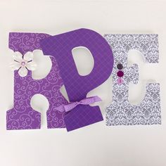 the letters are made out of paper and decorated with bows