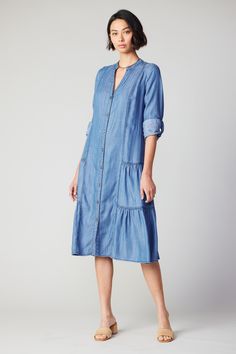 Lightweight and easy to wear, this chambray midi dress features a split neckline, tiered styling, and a relaxed fit that cinches with a coordinating tie belt. Roll up the sleeves and leave a button or two undone for a casual finish. •Split neckline •Button placket •Long sleeves •Barrel cuffs •Optional tie belt •Tiered skirt •Relaxed fit DIMENSIONS •Standard: 47"L Item number 2390077 100% Tencel ♦ Tencel is an eco-friendly fabric that reduces water usage while utilizing regenerated natural fibers Tencel Dress, Chambray Dress, Button Dress, Online Shopping Stores, Spring Collection, Tie Belt, Roll Up, Dresses Xs, Neck Designs