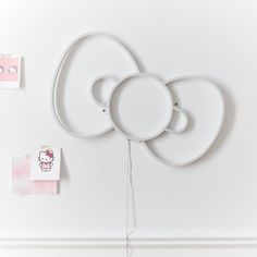 three white plates are hanging on the wall next to post it notes with hello kitty stickers