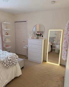 a bedroom with a bed, dresser and mirror