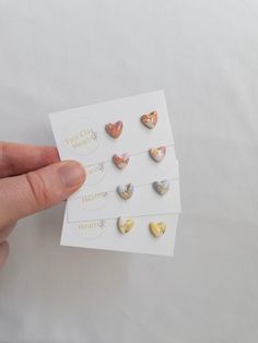 These heart earrings have a simple shape and small size making them perfect for the workplace. The use of gold leaf and resin gives a dash of shine on your ears while the stainless-steel backings make them comfortable all day long. Earring Material: Polymer Clay, Resin and Surgical Stainless Steel studs with butterfly backs Length: 0.8cm Width: 0.8cm NOTE: earrings on model are representative of this style only. Simple Resin Earrings, Polymer Clay Simple Earrings, Resin Studs, Polymer Clay Resin, Long Earring, Mini Gold, Earrings Inspiration