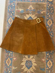 "1960's Brown Suede Leather Paneled Wrap Mini Skirt with Gold Brass Buckle  This skirt is so rock n roll! Woodstock, Almost Famous, Daisy Jones and the Six vibes 😍 Brand: Ardee California, USA  Fit: Small Waist: 26\" to 27.5\" Hip: up to 42\" Length: 17\" Condition: Good Vintage Condition. All sales are final. Thank you for shopping small + sustainable ❤️" Gold Aline Skirt, Vintage Brown Skirt For Party, Vintage Fall Party Skirt, Brown Mini Skirt Outfit, Suade Skirt, 70s Mini Skirt, 1960s Mini Skirt, Vintage Mini Skirts, 60s Mini Skirt