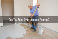 an older man is using a paint roller in his living room with the words can you paint over linoleum flooring?