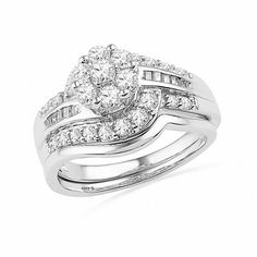 a white gold wedding ring set with two diamonds on each band and an oval shaped diamond in the center