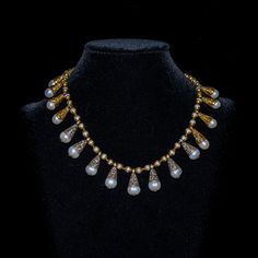 This 19" necklace combines the ancient regal look one can see on the old paintings with modern and ethnic materials. 16 nepalese teardrop pearl beads with repousse silver and brass caps sit on a strand of baroque white river pearls with brass caps. The dull gold of antiqued brass offsets the delicate whiteness of the pearls. A delicate brass antique magnetic clasp completes this necklace. A piece for a queen in your mirror or a queen of your heart! Traditional White Teardrop Necklaces, Traditional White Teardrop Necklace, Antique White Pearl Necklaces, Elegant Silver Beaded Temple Necklace, Elegant Silver Beaded Necklace For Ceremonial Use, Elegant Silver Beaded Necklace For Ceremonial Occasions, River Pearls, White River, Brass Antique