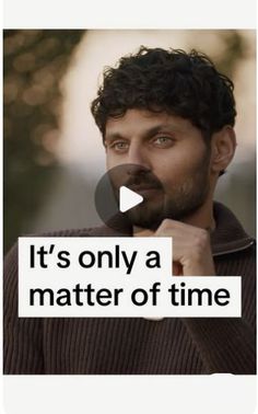 a man with curly hair and beard standing in front of a sign that says it's only a matter of time