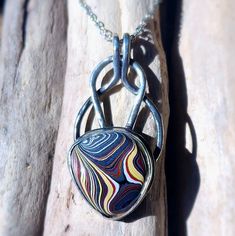 Very Colorful Corvette Fordite Pendant Necklace, Set In Sterling Silver. A 20 Inch Stainless Steel Chain Is Included. I Spend Hours Designing And Handcrafting Every Pendant. It's Very Rewarding For Me When I Start With Just Sterling Silver Sheet And Wire, And Make It Into A Unique And One Of A Kind Piece Of Jewelry. If You Would Like Additional Pictures, Please Let Me Know And I Will Take Some More. What Is Fordite? It's Overspray From Painting Cars, Trucks And Suv's At Assembly Plants As Well As Other Manufacturers Who Paint Car Parts. When The Paint Layers Build Up, It Eventually Gets Removed. From There I Purchase It And Then Cut, Shape And Polish Smaller Pieces To Be Used In My Jewelr Circle Designs, Unique Pendant Necklace, Circle Design, Full Circle, Car Painting, Steel Chain, Me When, Stainless Steel Chain, Necklace Set