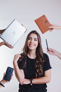 four people are holding their laptops and pointing to the same person's hand