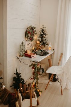 a room with christmas decorations and lights on the wall next to a desk, chair and window