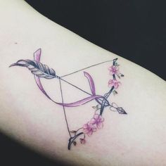 an arrow and bow tattoo with pink flowers on the side of a woman's arm