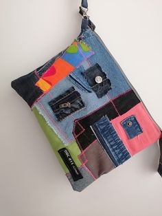 "Introducing our one-of-a-kind denim clutch, a unique and stylish accessory handcrafted from upcycled jeans. This rustic purse is the perfect gift for the fashion-conscious woman who values sustainability as much as she does style. Each piece is carefully crafted, featuring a chic patchwork design that brings together a range of denim shades, making every clutch a unique piece of wearable art. This denim clutch isn't just about style; it's about functionality too. The clutch measures approximately 8\"x5\", making it the perfect size to carry all your essential items like your phone, wallet, keys, and makeup. The sturdy denim material ensures durability, while the wristlet design adds convenience, allowing you to keep your belongings close at hand. The interior of the bag is lined with a so Everyday Denim Zipper Pouch Bag, Casual Clutch With Zipper Pouch, Casual Everyday Clutch With Zipper Pouch, Casual Denim Zipper Pouch Bag, Casual Clutch With Removable Pouch, Rectangular Denim Bag With Zipper Pouch, Casual Multicolor Pouch For Everyday Use, Casual Multicolor Zipper Pouch, Casual Multicolor Everyday Pouch