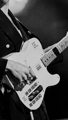 black and white photograph of a man playing an electric guitar