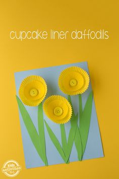 three paper flowers on top of a piece of paper with the words cupcake liner daffodils