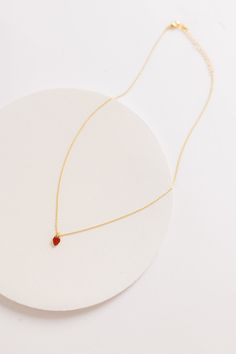 Delightful strawberry charm necklace 16" chain Approximate charm measurement - 1/4" Gold plated Jewelry Care: Lightly polish each jewelry piece with a soft cloth after wearing. Remove rings when washing hands. Do not shower or swim with your jewelry. Delicate Drop Charm Necklace For Gifts, Minimalist Red Birthstone Jewelry, Dainty Red Jewelry For Everyday, Red Jewelry With Adjustable Chain For Gift, Gift Red Jewelry With Adjustable Chain, Dainty Red Birthstone Jewelry, Red Dainty Birthstone Jewelry, Red Drop Necklace For Gift, Red Drop Jewelry For Gift