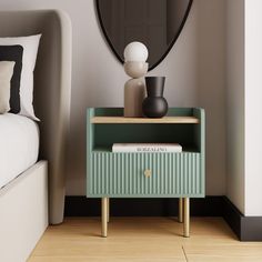 a nightstand with a mirror and vase on it in a room that has wood flooring