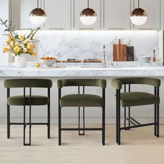 a kitchen with marble counter tops and four chairs in front of the island, surrounded by hanging lights