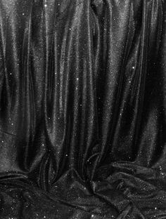 black and white photograph of fabric with glitter on the top, as if it were clothing