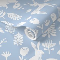 a blue and white wallpaper with rabbits, flowers and leaves on the background that is very soft