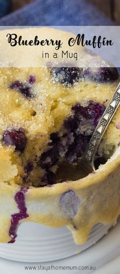 blueberry muffin in a mug on a white plate with a spoon and text overlay