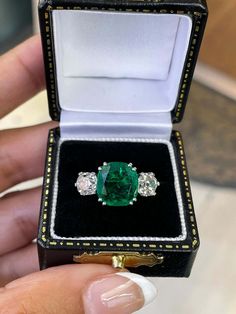 Gift Emerald Ring With Three Stones In Radiant Cut, Classic Three Stone Emerald Jewelry, Three Stone Cushion Cut Ring, Formal Emerald Three-stone Ring, Formal Three-stone Green Jewelry, Formal Green Three Stone Jewelry, Formal Green Three-stone Jewelry, Luxury Emerald Ring With Three Stones And Radiant Cut, Luxury Three Stone Radiant Cut Emerald Ring