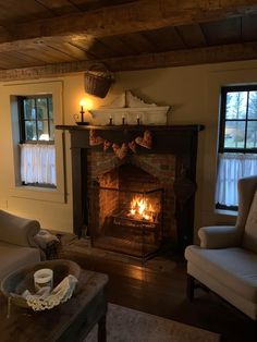 a living room filled with furniture and a fire place in the middle of it's fireplace