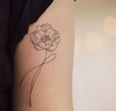 a single flower tattoo on the arm