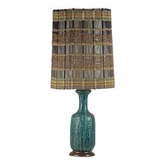 a green table lamp with a brown and blue shade