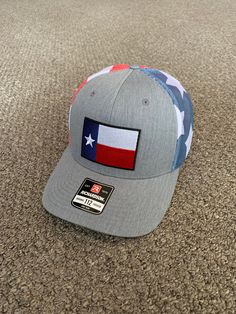 "This is a NEW Texas Flag embroidered patch applied by hand to a high quality Yupoong or Richardson brand SnapBack Trucker style hat Yupoong Classic SnapBacks are 65% Polyester/35% Cotton Structured mid-profile six-panel Permacurv Visor adjustable 6 7/8\" to 7 1/2\" Richardson Hats are 60% cotton/40% polyester Structured mid-profile six-panel Pre-curved Visor adjustable snapback closure 6 3/4\" -7 5/8\" Every Hat Design we offer is Created and Individually HANDCRAFTED to order in the USA! *Due t Snapback Hat One Size Fits Most Made In Usa, One Size Fits Most Snapback Hat Made In Usa, Adjustable Snapback Hat With Patches And Curved Brim, Adjustable Hat With Patches And Curved Bill, Casual Curved Bill Hat With Patches, Casual Flat Brim Hat With Patches, Casual Flat Bill Hat With Patches, Trucker Hat With Curved Brim Made In Usa, One Size Snapback Hats With Patches