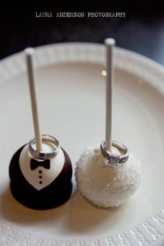 two wedding rings are placed next to each other on a plate