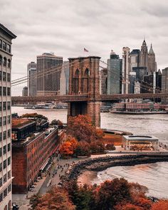 an aerial view of the brooklyn bridge and lower manhattan, new york city in autumn