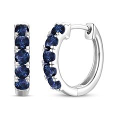 These petite hoop earrings from the Natural Precious Gemstones by KAY collection are a striking choice. Crafted in 10K white gold, each earring features five beautiful round-cut blue sapphires. These earrings secure with hinged backs. Sapphire Round Hoop Earrings Fine Jewelry, Sapphire Hoop Earrings Fine Jewelry, Fine Jewelry Sapphire Hoop Earrings In White Gold, Blue Hoop Earrings With Prong Setting For Anniversary, Blue Round Hoop Earrings For Anniversary, Blue Hoop Earrings With Prong Setting, Sapphire Sterling Silver Hoop Earrings, Blue Round Hoop Earrings For Formal Occasions, Formal Blue Round Hoop Earrings