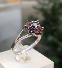 czech garnet  ring 2.84 grams size 8 us 18 ru Raw Red Garnet Flower Ring // Alternative Unique Organic Rustic  Czech Almadine Red Gemstone Natural Garnet  Ring This listing is for one raw Garnet wave ring. Pictured ring is in 925 sterling silver. DETAILS: Stone:  Almadine Garnet A gorgeously lavish vintage red garnet cluster ring made in gilt silver from the 1960s. There are four tiers of wine-red Bohemian garnets set in an undulating oval bezel setting, rising towards the larger oval garnet in Garnet Gemstone Cluster Ring Gift, Garnet Cluster Ring As A Gift, Garnet Birthstone Cluster Ring For Anniversary, Promise Ring With Hallmarked Garnet Birthstone, Garnet Gemstone Cluster Ring, Formal Garnet Gemstone Cluster Ring, Anniversary Garnet Gemstone Cluster Ring, Fine Jewelry Garnet Rings Hallmarked, Fine Jewelry Hallmarked Garnet Rings