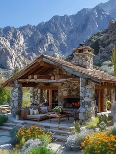 an outdoor living area in front of mountains