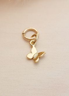 This gold filled butterfly charm is a stunning addition to any charm bracelet or necklace. Made with high-quality 14k gold vermeil, it makes for a thoughtful gift for Mother's Day. The intricate design of the butterfly is a perfect representation of love and transformation. Add this unique charm to your collection today. Dimensions: 14.6 x 8.6mm Ring Spacer, Hoop Charms, Layered Chains, Gold Butterfly, Butterfly Charm, The Butterfly, Intricate Design, Bridal Gifts, Unique Charms