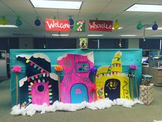 an office cubicle decorated with brightly colored paper houses