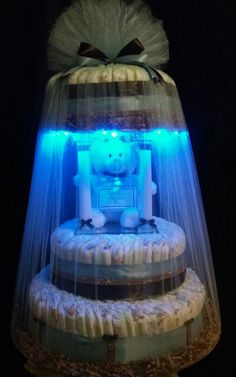 a white teddy bear sitting on top of a cake covered in frosting and lights