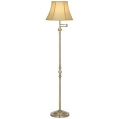 a floor lamp with a beige shade on it's side and a white background