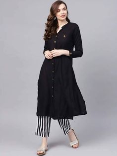 Look elegant and stylish at your next big event in this Black kurta set from Riafashions. Wear this kurta set with the accessories of your choice for a fashion-forward look. This High-Quality Rayon Cotton Silk Set Features: Straight calf length kurta, has a mandarin collar, mock button detail, three-quarter sleeves, straight hem, multiple slitsBlack and white striped trousers, has elasticated waistband Black And White Striped Trousers, Anarkali Dress Indian, Black Kurta Set, White Striped Trousers, Free Stitching, Cotton Anarkali Kurta, Black Frock, Black Kurta, Cotton Anarkali