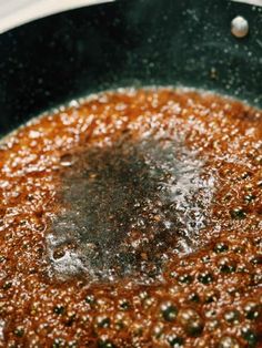 a frying pan filled with food cooking on top of a stove burner and water