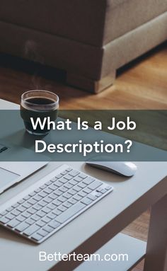 a coffee cup sitting on top of a desk next to a keyboard and mouse with the words, what is a job description?